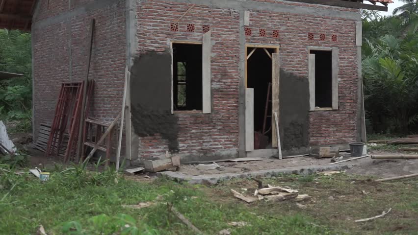 Unfinished Brick House Construction in the Middle of Garden Area