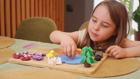 Young girl makes a miniature pond with clay, adding ducks and flowers - Powered by Shutterstock - Get 15% off with code: PIKWIZARD15