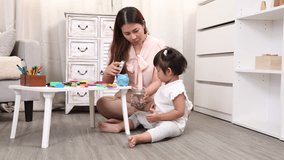 Asian little girl preschool kid learning saving put a coin into piggy bank by mother teaching, creating a playful and educational moment of family bonding and early financial education development - Powered by Shutterstock - Get 15% off with code: PIKWIZARD15