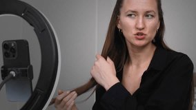 Young woman influencer recording video blog while creating content, using ring light for professional illumination and engaging social media followers from home setting - Powered by Shutterstock - Get 15% off with code: PIKWIZARD15