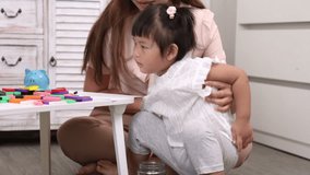 Asian little girl preschool kid learning saving put a coin into piggy bank by mother teaching, creating a playful and educational moment of family bonding and early financial education development - Powered by Shutterstock - Get 15% off with code: PIKWIZARD15