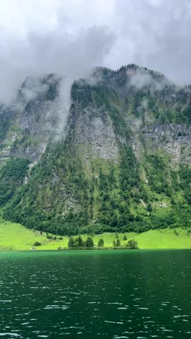 Mountain lake landscape with clouds. Königssee in the Bavarian Alps mountains, German national reserve