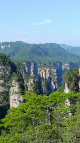 Aerial portrait flying over rocky cliffs in Huangshi, Zhangjiajie park, China