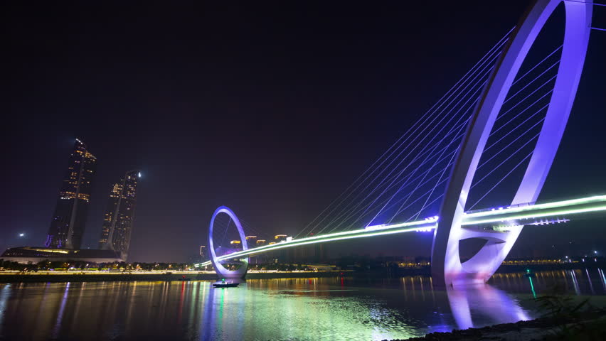 nanjing night illumination famous international youth cultural center riverside pedestrian bridge timelapse panorama 4k china