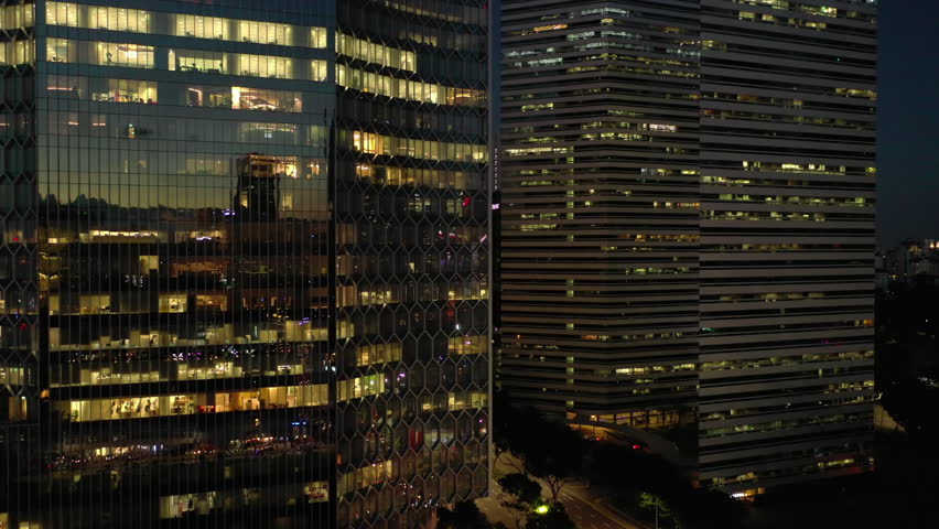 SINGAPORE - February 10, 2024: night sunset illumination city downtown office buildings front aerial panorama 4k