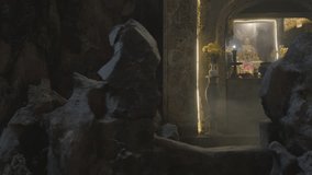 Smoke dissipating, revealing sacred shrine honoring goddess, surrounded by flickering candles, delicate flowers inside marble mountain cave, vietnam's spiritual landscape - Powered by Shutterstock - Get 15% off with code: PIKWIZARD15