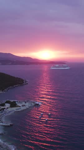 Serene seascape with cruise ship and sunset glow near Ksamil Albania vertical