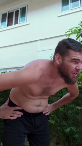 Man examining his belly with dissatisfaction