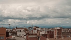 Dramatic 4K view of storm clouds rolling above city rooftops. Perfect for intros, documentaries, or weather-themed footage needing atmosphere and tension. - Powered by Shutterstock - Get 15% off with code: PIKWIZARD15