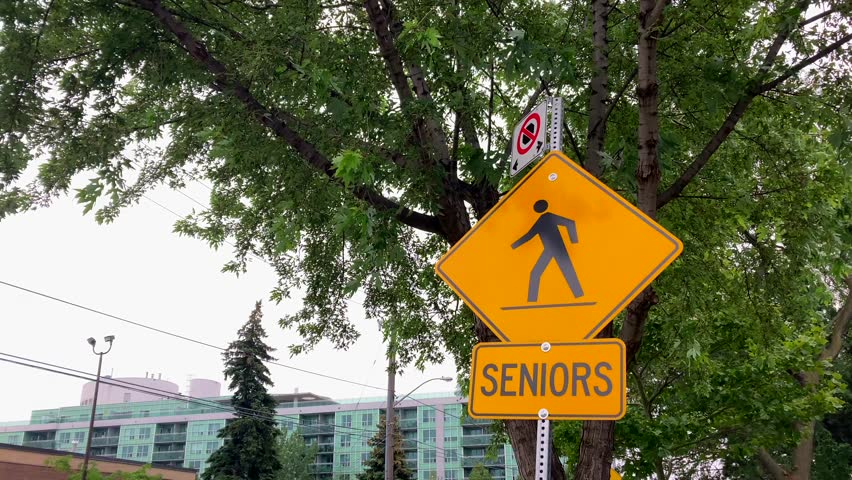 Senior citizens pedestrian safety road traffic warning sign in urban neighborhood