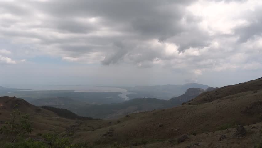 Time lapse clip of heavy clouds over a mountainous landscape