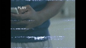 Mobile tech user taking water bottle from friend to hydrate while VHS streaming static lines. Technology, friendship, hydration, vintage, casual, lifestyle, communication - Powered by Shutterstock - Get 15% off with code: PIKWIZARD15