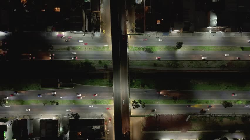 Night aerial hyperlapse on an avenue with car movement and lights