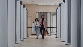 Happy customers walking through a shopping mall changing rooms - Powered by Shutterstock - Get 15% off with code: PIKWIZARD15