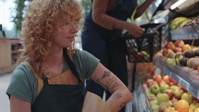 Fruit seller arranging fresh produce on display in slow motion - Powered by Shutterstock - Get 15% off with code: PIKWIZARD15