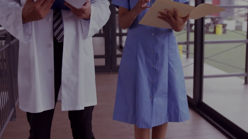 Doctor noting and nurse examining file for medical analytics, grid lines and charts appearing. Medical, clinical, healthcare, analytics, data, visualization, teamwork - Powered by Shutterstock - Get 15% off with code: PIKWIZARD15