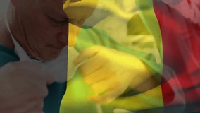 Surgeon prepping for surgery securing mask and cap straps under waving Guinea flag overlay. Medical, healthcare, protective, sterile, professional, precision, clinical - Powered by Shutterstock - Get 15% off with code: PIKWIZARD15