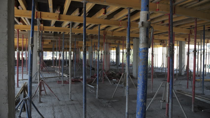 Concrete floor under construction with formwork and support props