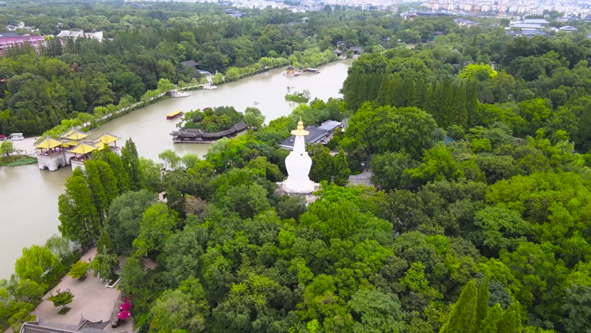 Aerial view of Slender West Lake featuring the iconic White Pagoda surrounded by lush greenery in Yangzhou, Jiangsu Province, China
