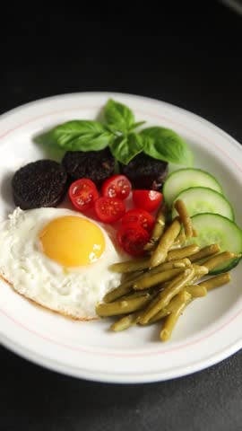 English breakfast fried egg, black pudding, vegetables, beans fresh delicious gourmet food background on the table rustic food top view copy space