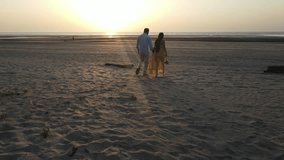 A romantic moment of a young man lifting his partner in his arms while standing in shallow sea water at the beach during sunset. The couple shares an intimate gaze, surrounded by a calm ocean and soft - Powered by Shutterstock - Get 15% off with code: PIKWIZARD15