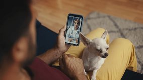 Male owner with dog on lap calling veterinarian, telemedicine consultation - Powered by Shutterstock - Get 15% off with code: PIKWIZARD15