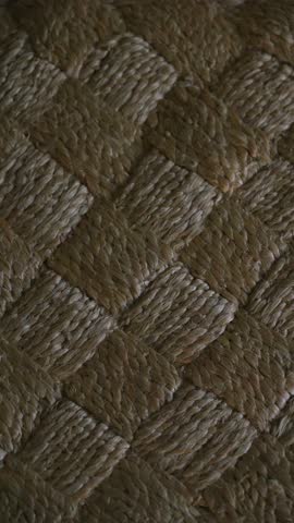 Static vertical dark low light moody natural seagrass texture fabric rustic wabi sabi boho style jute carpet with square tiles geometric pattern perfect background for social media story telling