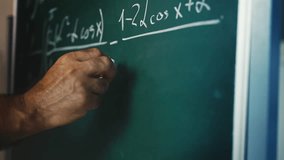 Male math teacher writing equations on chalkboard during university lecture - Powered by Shutterstock - Get 15% off with code: PIKWIZARD15