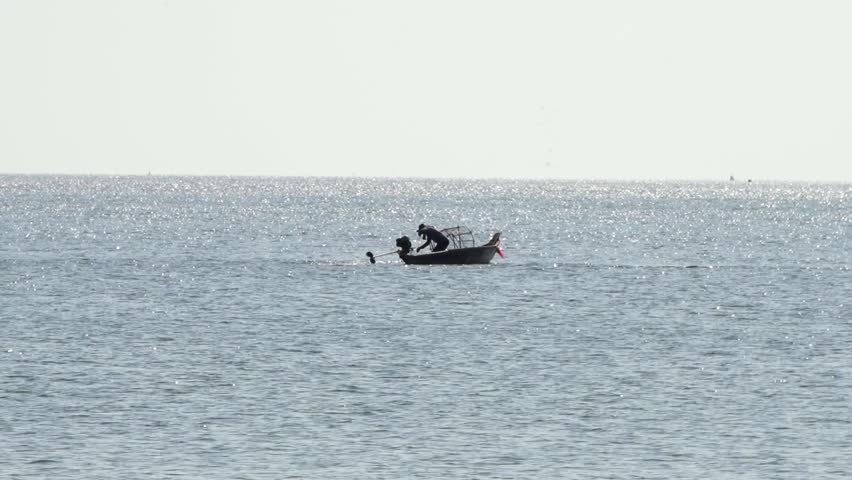 Fishing boat with fisherman in the sea