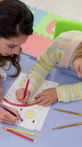 Psychology, coloring and therapist with child for creative, art or self expression for ADHD assessment. Paper, drawing and top view of psychologist with girl kid for fine motor skills or development.