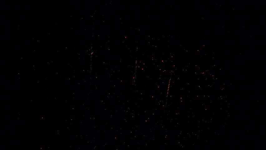 Vibrant fireworks burst and cascade in night sky celebration display