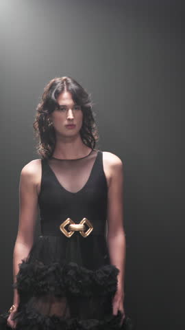 Girl, runway and model for fashion, show and evening gown with confidence, design and style expo. Woman, couture clothes and stage with garment collection on catwalk, trend and audience at event