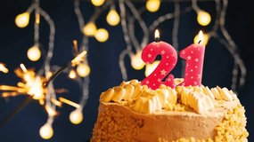 Celebrate the milestone 21st birthday with a festive cake topped by a pink number 21 candle. Captured in slow motion as the candle is blown out, set against a vibrant lighting background. - Powered by Shutterstock - Get 15% off with code: PIKWIZARD15