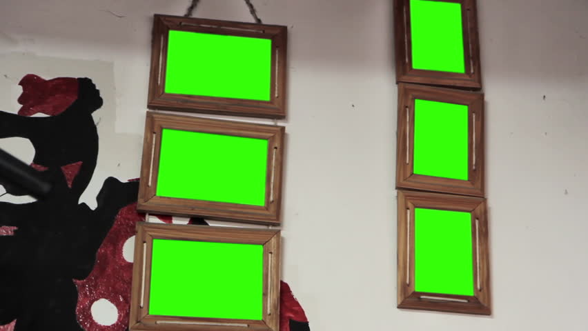 Multiple Wooden Picture Frames With Green Screen Hanging on Interior Wall   - Powered by Shutterstock - Get 15% off with code: PIKWIZARD15