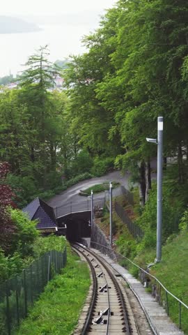 Vertical view of ascending Mount Floyen funicular with Bergen city panorama, Norway