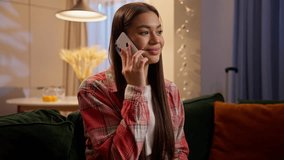 Caucasian woman talking mobile phone indoor conversation friendly chatting girl teen female speaking cellphone smiling answer call laughing pleasant communicate relax on couch sofa home night evening - Powered by Shutterstock - Get 15% off with code: PIKWIZARD15