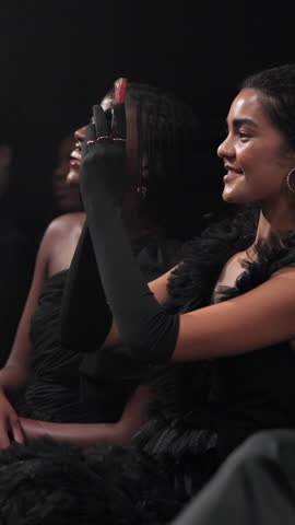 Woman, phone and picture with audience at fashion show, runway event and clothing designer. Crowd, entertainment and person recording with mobile for clothes launch, premiere and showcase collection