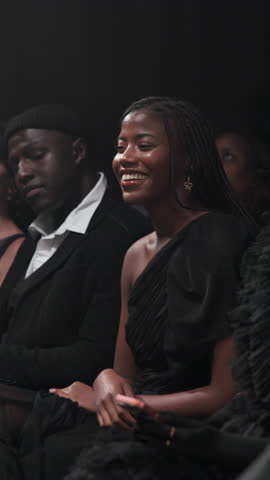 Crowd, gala and smile of woman at fashion show for runway event as clothing designer or stylist. Audience, entertainment and presentation with happy person at launch or premiere of clothes brand