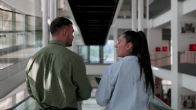latino colleagues walking and talking in the hallway of a modern building - Powered by Shutterstock - Get 15% off with code: PIKWIZARD15