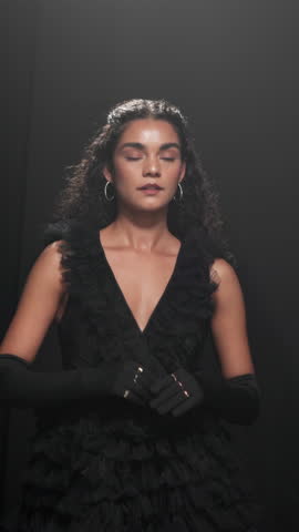 Girl, runway and model for fashion week, show or dress for design, confident or style at expo. Woman, couture clothes and stage in evening gown on catwalk, gloves or collection for audience at event