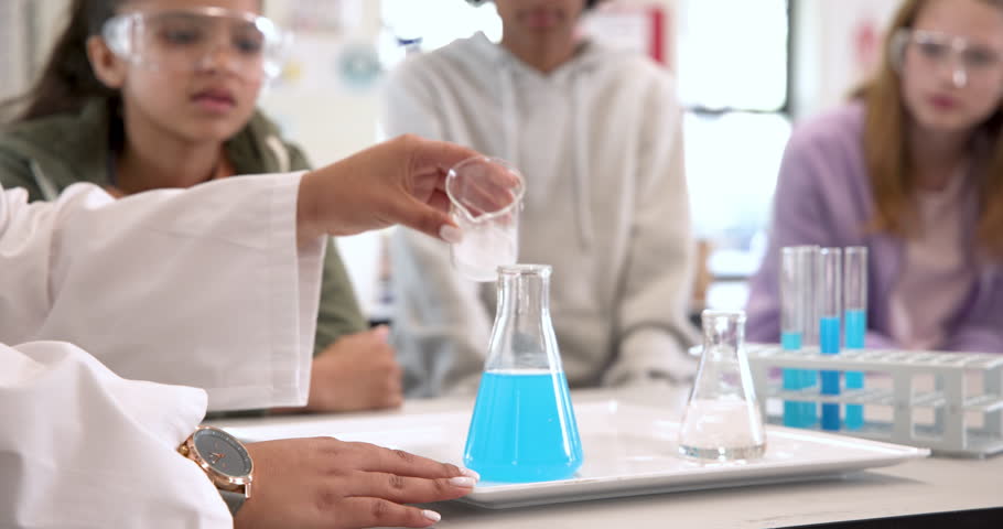 Multiracial students in science class observing exciting chemical reaction, at school. laboratory, experiment, education, chemistry, learning, curiosity