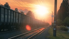 Freight Train Moving on Railway Tracks at Golden Sunset with Lens Flare Effect - Powered by Shutterstock - Get 15% off with code: PIKWIZARD15
