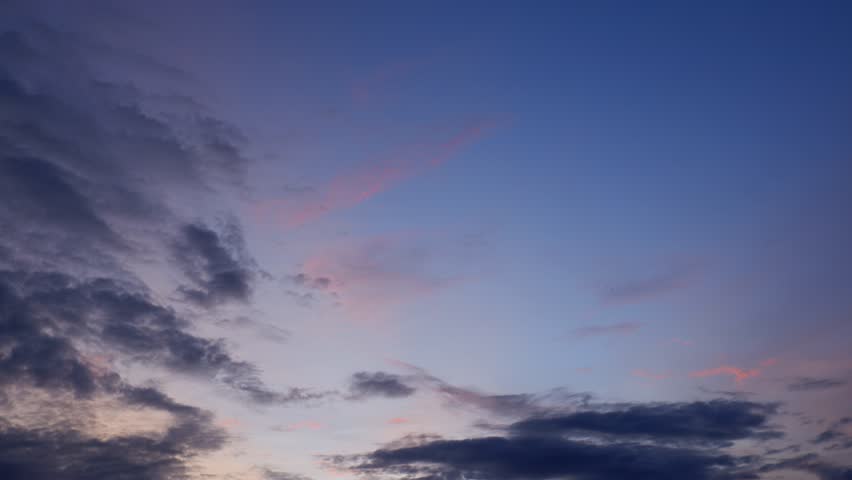 A sunset timelapse showcasing a gradient sky from soft pinks to deep purples, with scattered clouds gently shifting, creating a peaceful transition from day to night filled with calm and warmth.

