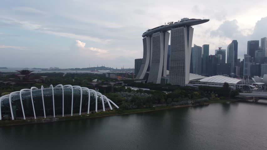 20 May 2025 - Singapore Aerial drone shot of marina bay sands, with the Singapore skyline in the background. In the front the cloud forest is visible.