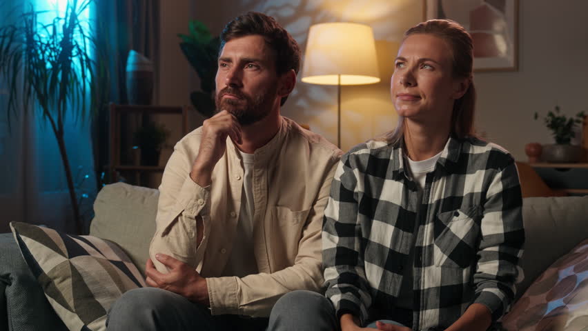 Thoughtful woman man Caucasian family married couple pensive unhappy tenants homeowners at evening night home sad thinking doubt husband wife girl guy upset think problem real estate loan mortgage