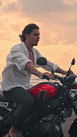 Person Riding Bike in Summer Landscape of Beach Traveling in Outdoors Nature. Handsome Motorcyclist or Surfer Driving Motorcycle in Speed Shot. Lifestyle of Alone Man in Motion on Stylish Transport