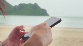 Closeup of woman hands using mobile smartphone at the beach in sunny day. Business, financial, trade stock market and social network concept. - Powered by Shutterstock - Get 15% off with code: PIKWIZARD15