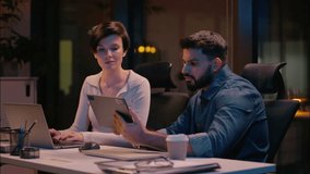 Multiethnic businessman businesswoman business co-workers partners Caucasian woman Indian man colleagues designers girl guy using gadgets in office night evening working laptop digital tablet website - Powered by Shutterstock - Get 15% off with code: PIKWIZARD15