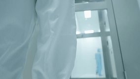 scientist in white protection suit walking through the air shower blowing disinfect machine to clean before working inside the lab, hygiene standard routine procedures before entering laboratory - Powered by Shutterstock - Get 15% off with code: PIKWIZARD15