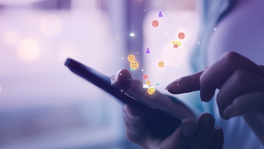 Close-up of hands holding smartphone with floating social media icons, symbolizing digital interaction, real-time communication, and online user engagement for modern technology and lifestyle themes.